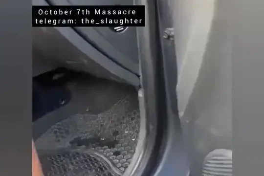 Two young women hiding behind a car while Hamas Hamas terrorists shoot at them